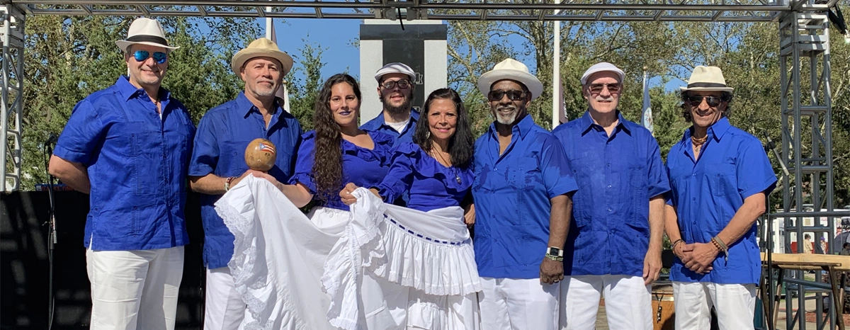 Singing group pdress in blue posing on stage
